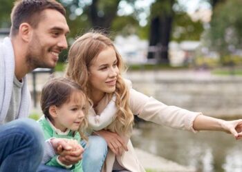 Adoptive parents with their newly adopted daughter.